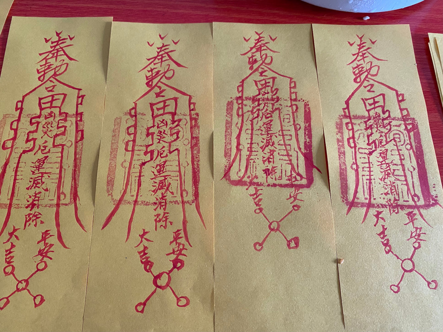 The master hand-painted cinnabar yellow talismans attract wealth, bring blessings, and ensure peace.